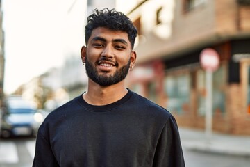 Young arab man smiling confident at street