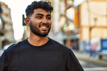 Young arab man smiling confident at street