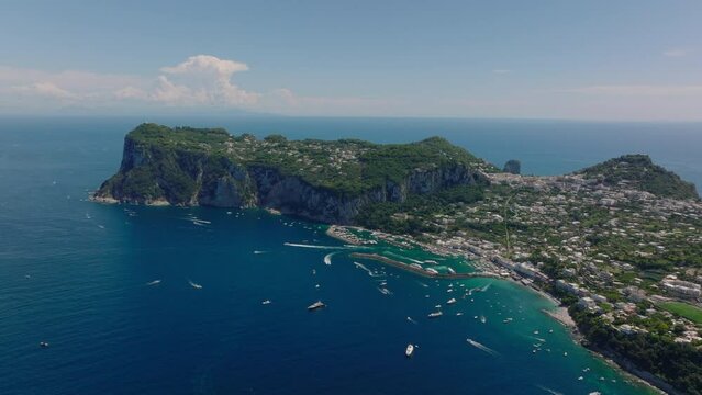Breathtaking aerial view of island in Mediterranean sea. Travel destination with town and harbour. Capri, Campania, Italy