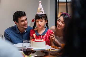 Multi-ethnic big family having a birthday party for young kid daughter