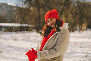 A beautiful woman in winter clothes is enjoying the winter. Christmas and New Year celebration concept.