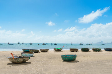 Fototapeta na wymiar Basket boats at My Khe beach in Da Nang city, Vietnam. Local fishing boats of Danang have become iconic to Vietnam. Southeast Asia travel concept