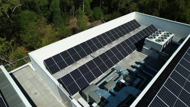 Aerial view of a air ventilation system and solar cells on a roof - pan, drone shot