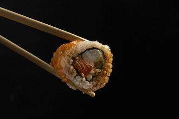 delivery of sushi roll at home with Chinese sticks and ginger