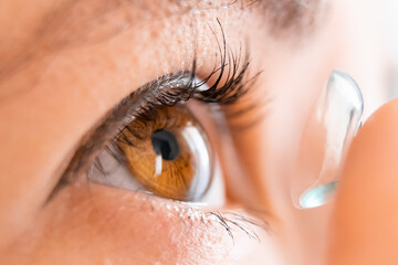 Close up woman applying contact lenses. Vision correction concept.