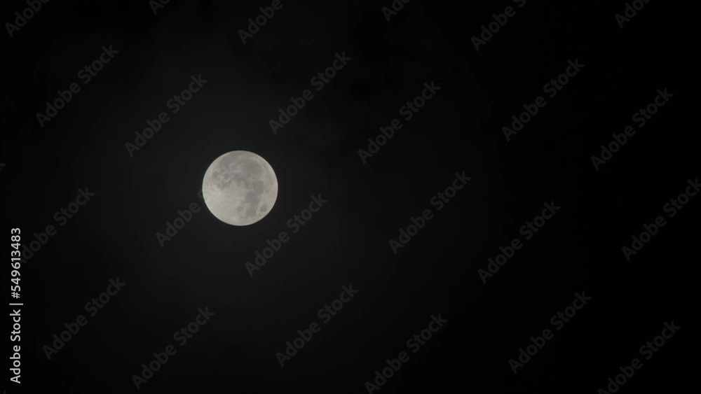 Poster full moon with clouds moving over it - penumbral lunar eclipse 11-08-2022