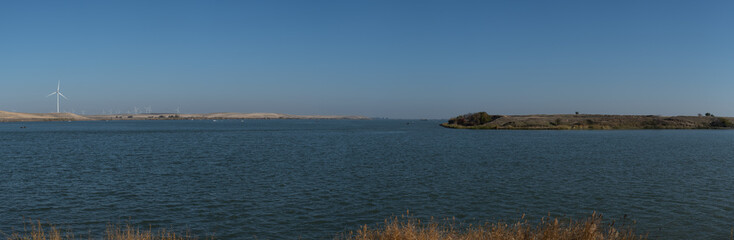 Wind turbines for electricity renewable energy off the water edge in the delta 
