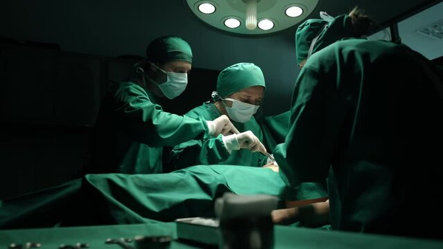 Medical team performing surgery in operation room.