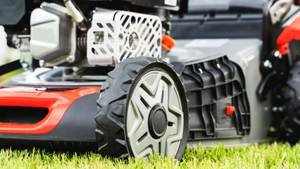 lawn mower with sunlight on green grass