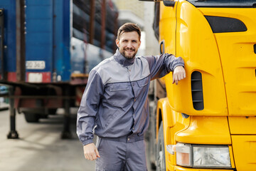 A truck driver is leaning on a truck and getting ready for goods delivery.