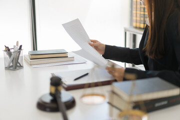 Law and justice concept, Female lawyer is reading agreement of contract while working in law firm