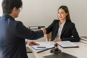 Law concept, Businessman shaking hands with female lawyer after deal and agreement contract