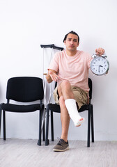 Young injured man waiting for his turn in hospital hall