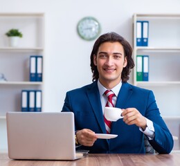 Young male businessman working in the office