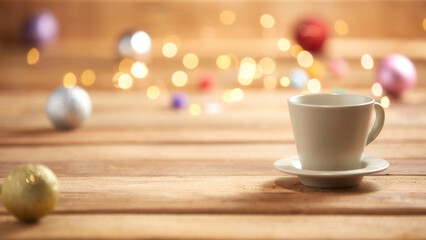 Fototapeta na wymiar christmas lights and coffee cup on wooden background