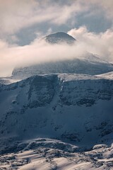 Landscape of Snowy Mountains Alps with cloudy sky in Hallstatt, Austria, vertical shot