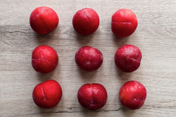 Fresh plums isolated on wooden table background