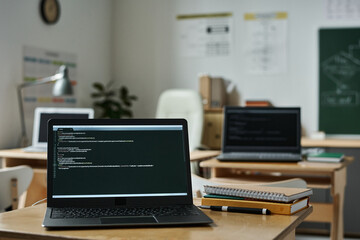 Close-up of laptop on desk with new software on screen in classroom to study IT technology