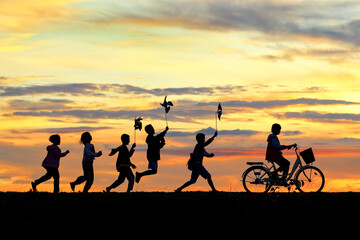 Silhouettes of children running around funny in the morning.