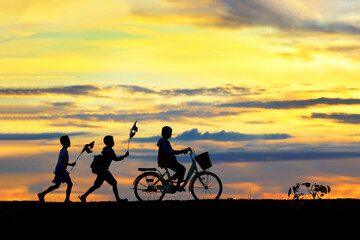 Silhouettes of children running around funny in the morning.