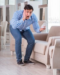 Fototapeta premium Young man shopping in furniture store
