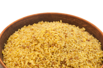 bulgur in a clay bowl on a white background. the concept of a good harvest of bulgur