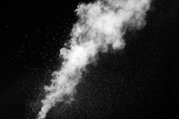 A jet of hot steam with splashes. The movement of hot steam with water droplets is highlighted on a black background to overlay your photos. Steam background, abstract smoke on a black background.