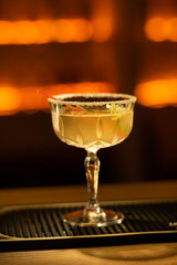 Traditional cocktail daiquiri. Decorated with sugar at bar background. Background blurred.