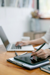 Fototapeta premium Businessperson Analyzing business information On Digital Tablet at office.