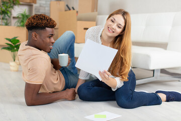 casual young couple discussing moving with packed boxes around