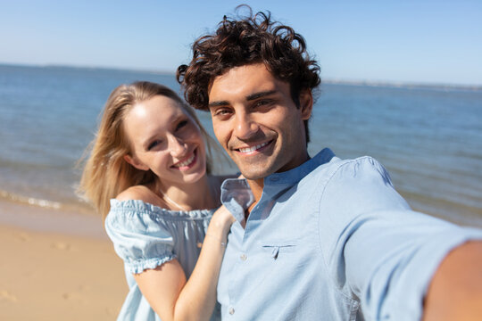 selfie photo of young couple in love near the ocean
