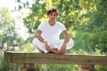 young handsome man doing yoga meditation exercise