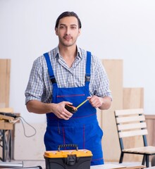 Young male carpenter working indoors