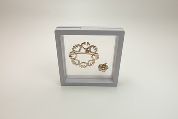 brooch in a box with a white background