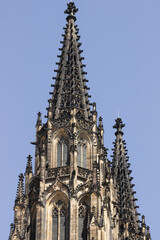 Fototapeta na wymiar Gothic black tower of St. Vitus cathedral against blue sky in Prague Castle complex, Czech Republic. Great architecture.