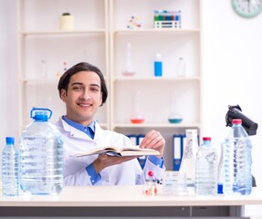 Young male chemist experimenting in lab