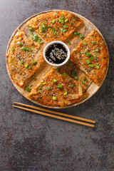 Kimchijeon South Korean pancake incorporates sliced kimchi served with a dipping sauce and...