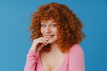 Fototapeta na wymiar White ginger woman with curly hair smiling and looking at camera