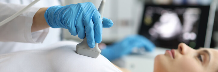 Doctor makes woman breast ultrasound, treatment before breast augmentation, full checkup in clinic