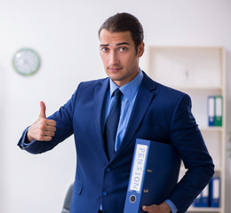 Young male accountant working in the office