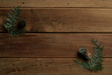 pine cones and leaves on vintage wooden background, winter mood