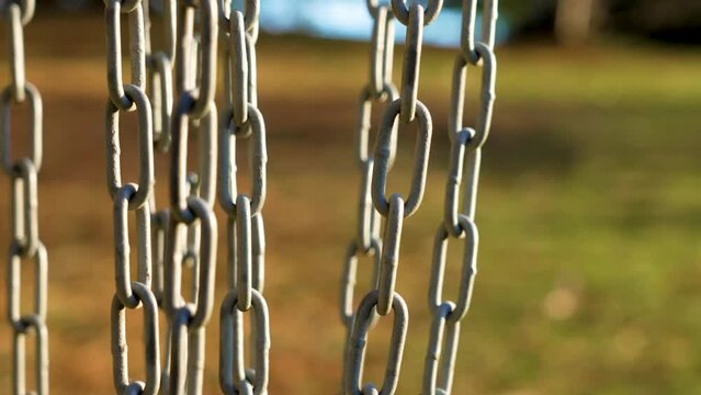Metal chain disc golf basket close-up. Recreational leisure activity equipment in autumn