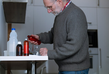 Adult man making body lotion at home