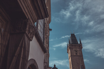 Clock tower in the central square in prague, czech republic on a sunny autumn day. Looking with...
