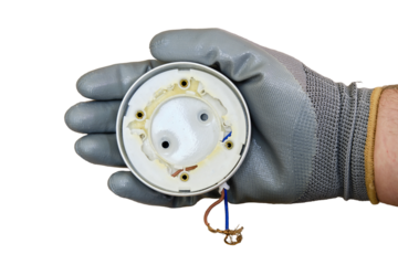 Burnt ceiling light bulb holder with broken plastic, isolated on a white background. Problem with modern electric lamp