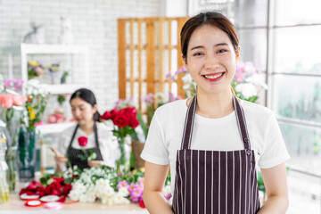 group of female florists Asians are arranging flowers for customers who come to order them for various ceremonies such as weddings, Valentine's Day or to give to loved ones.