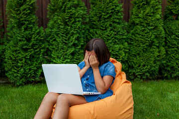 girl with a laptop in the garden