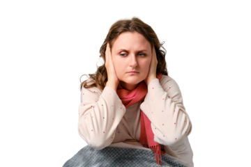 A sick woman holds on to her sore ears, pain and tinnitus, isolated on a white background. Adult ill woman sitting on a home bed in a white bedroom, female aged 35 years