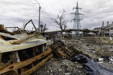 burnt cars and destroyed buildings of the workshop of the Azovstal plant in Mariupol