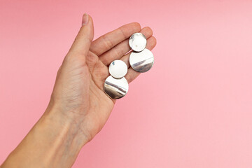 Silver jewelry on a pink background